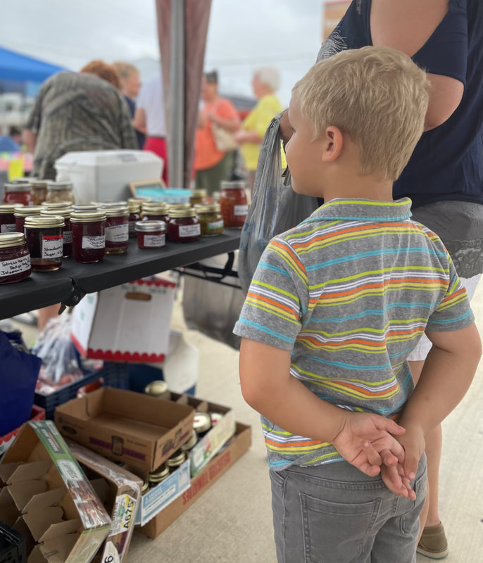 Child looking at homemade jelly